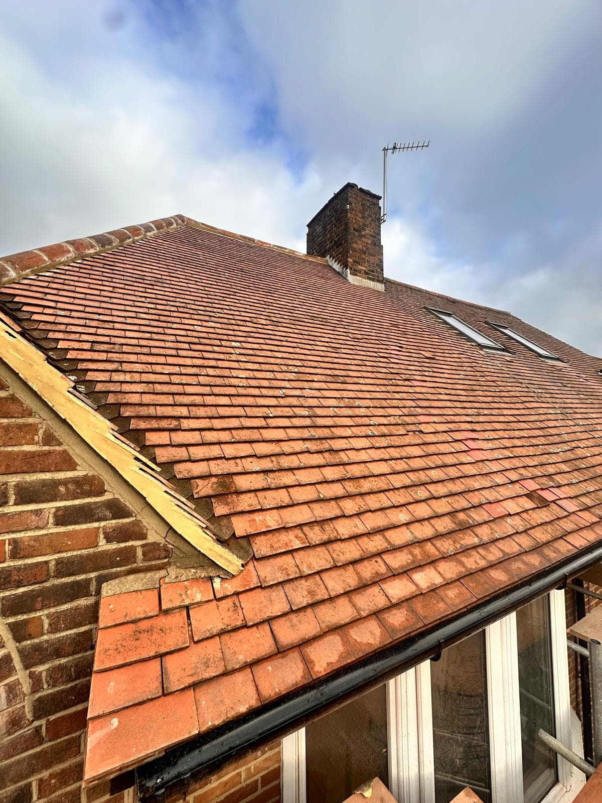 Red clay tile roof with chimney stack