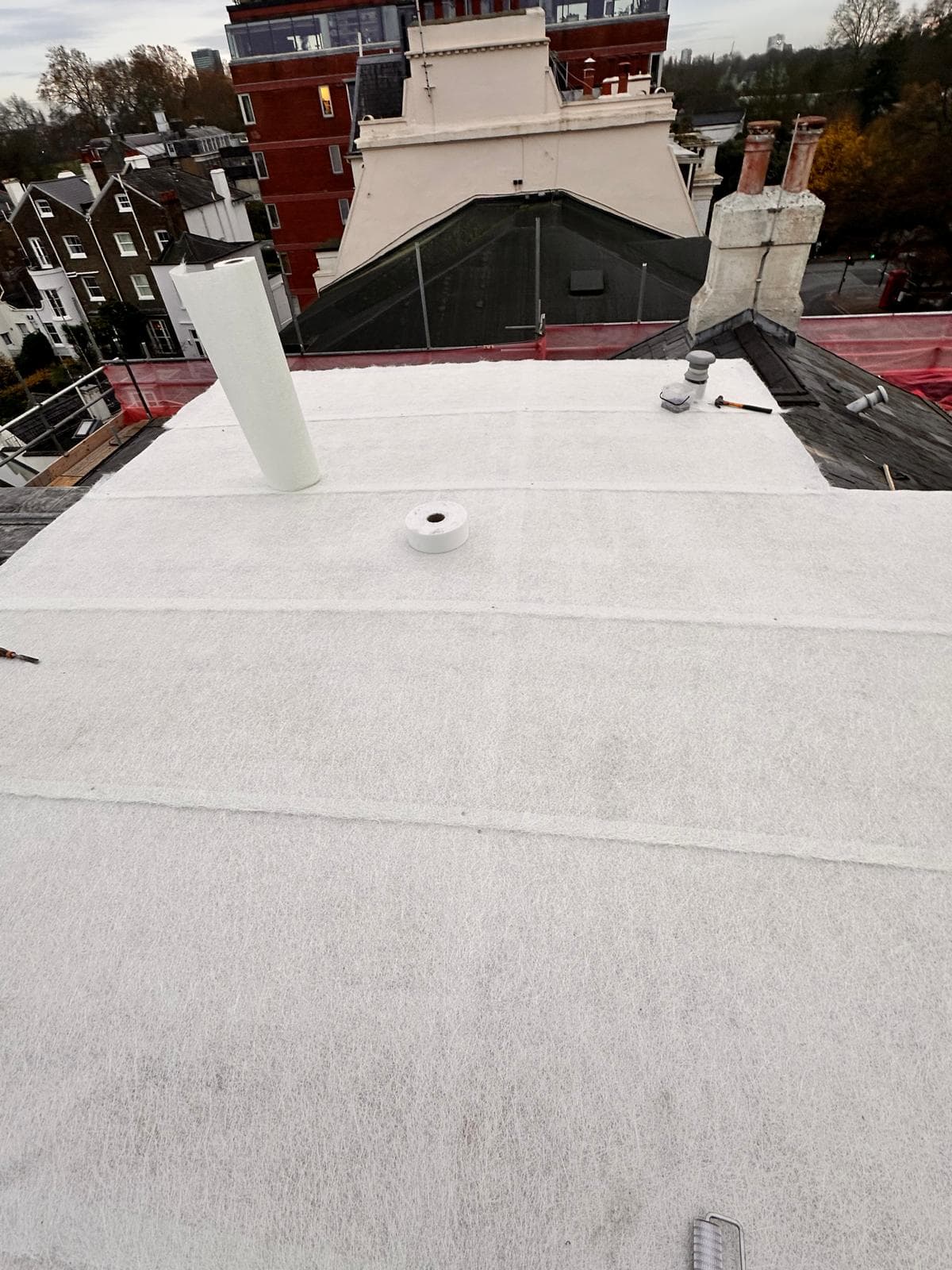 White GRP flat roof with chimneys